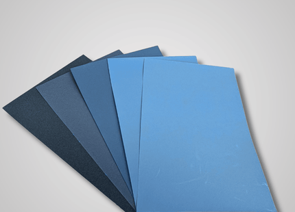 Set of blue and gray textured sheets on a light gray background