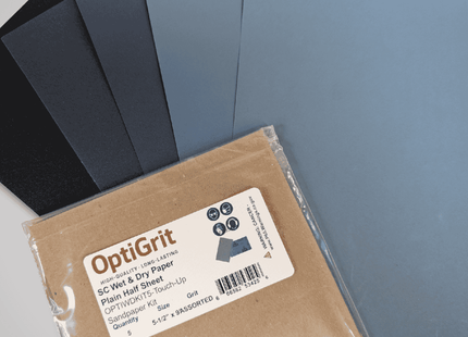 Packaged OptiGrit sandpaper sheets with a label on a gray background